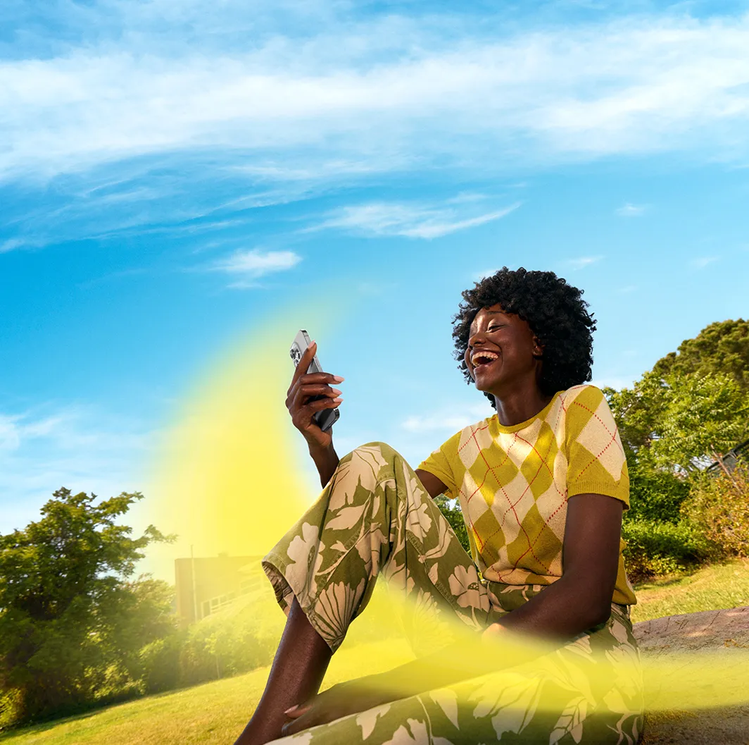 Niba — smiling customer checking her energy app outdoors